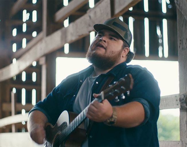 Shane Profitt playing guitar and singing