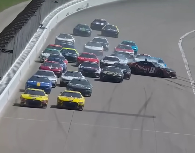 Kyle Busch sliding in the #8 car through a pack of cars racing at Kansas Speedway 05-07-23