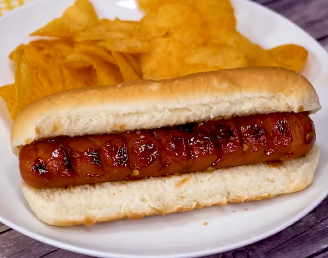 A hot dog and chips on a plate